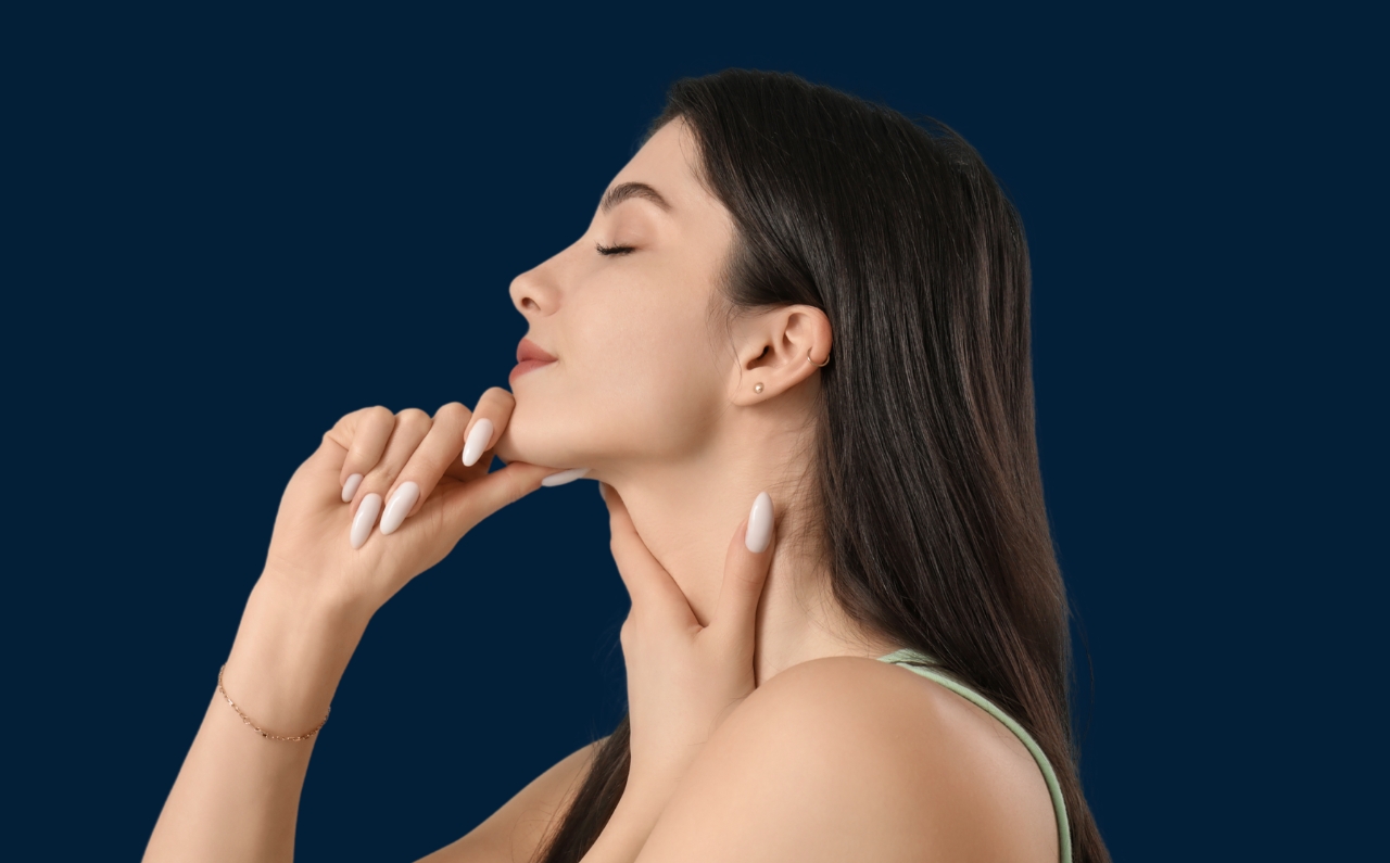 1. Practise Good Posture & Facial Exercises Woman doing a facial exercise with chin tilted upward, promoting skin firmness and complementing HIFU treatment results.