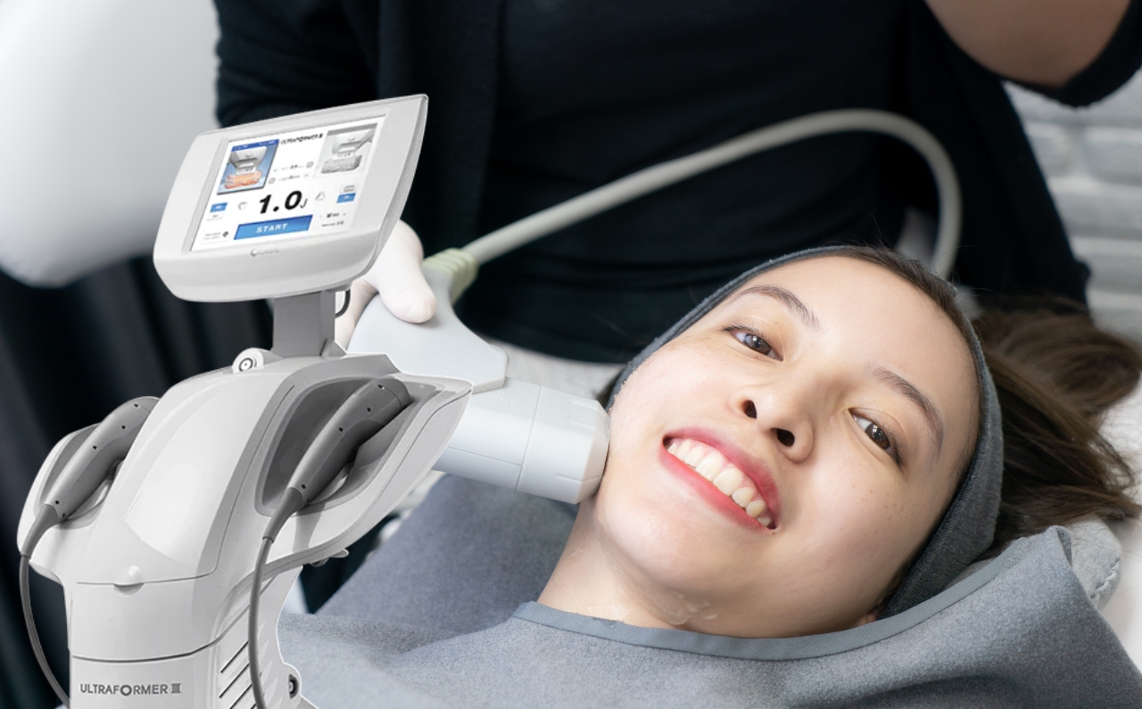 Aesthetician performing HIFU treatment to naturally lift and sculpt the V-shape face of a patient.