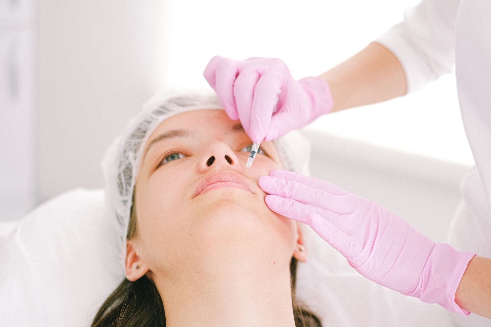 Woman receiving a precise cosmetic injection from a clinician
