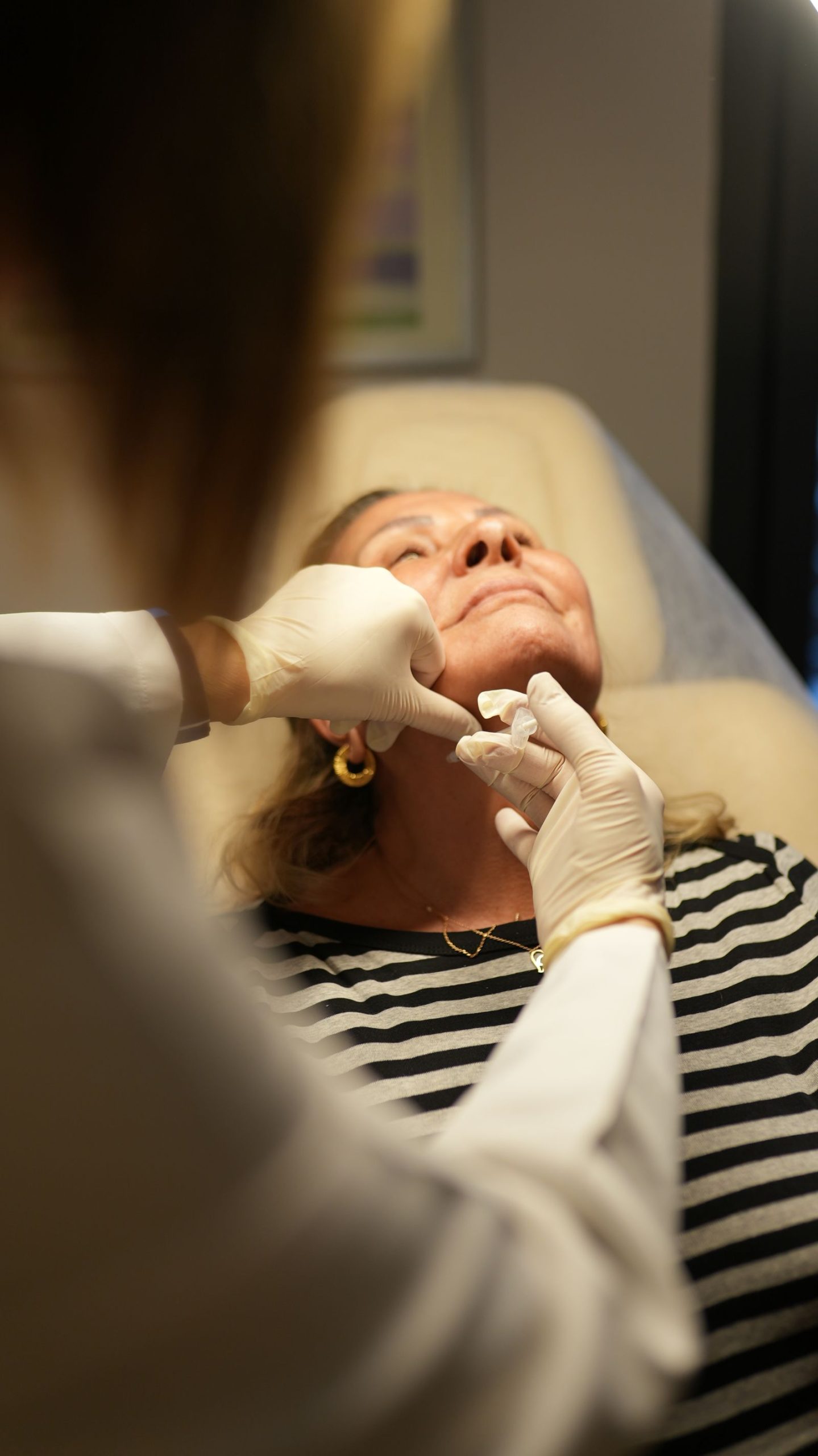Patient receiving a professional cosmetic facial treatment in a clinic