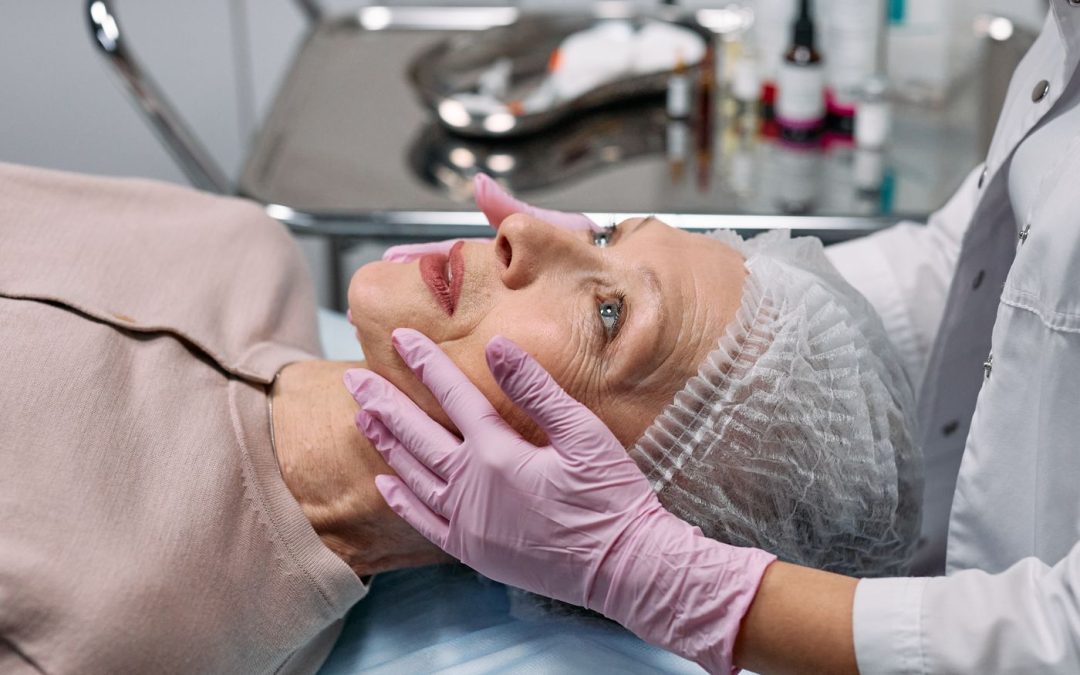Medical professional examining the face of an older patient