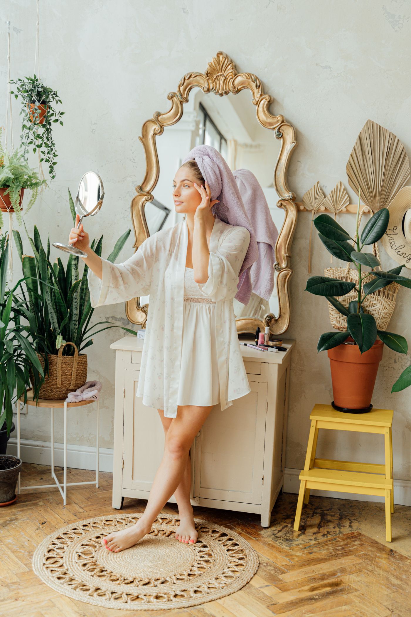 Woman checking her facial appearance in a mirror during a skincare routine