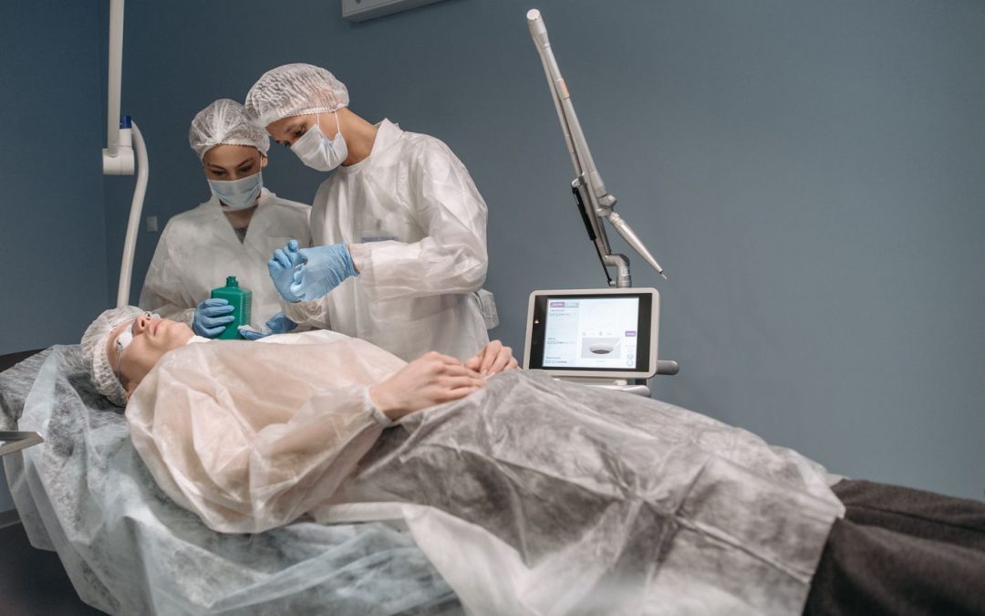 Two clinicians attending a patient during a planned cosmetic procedure
