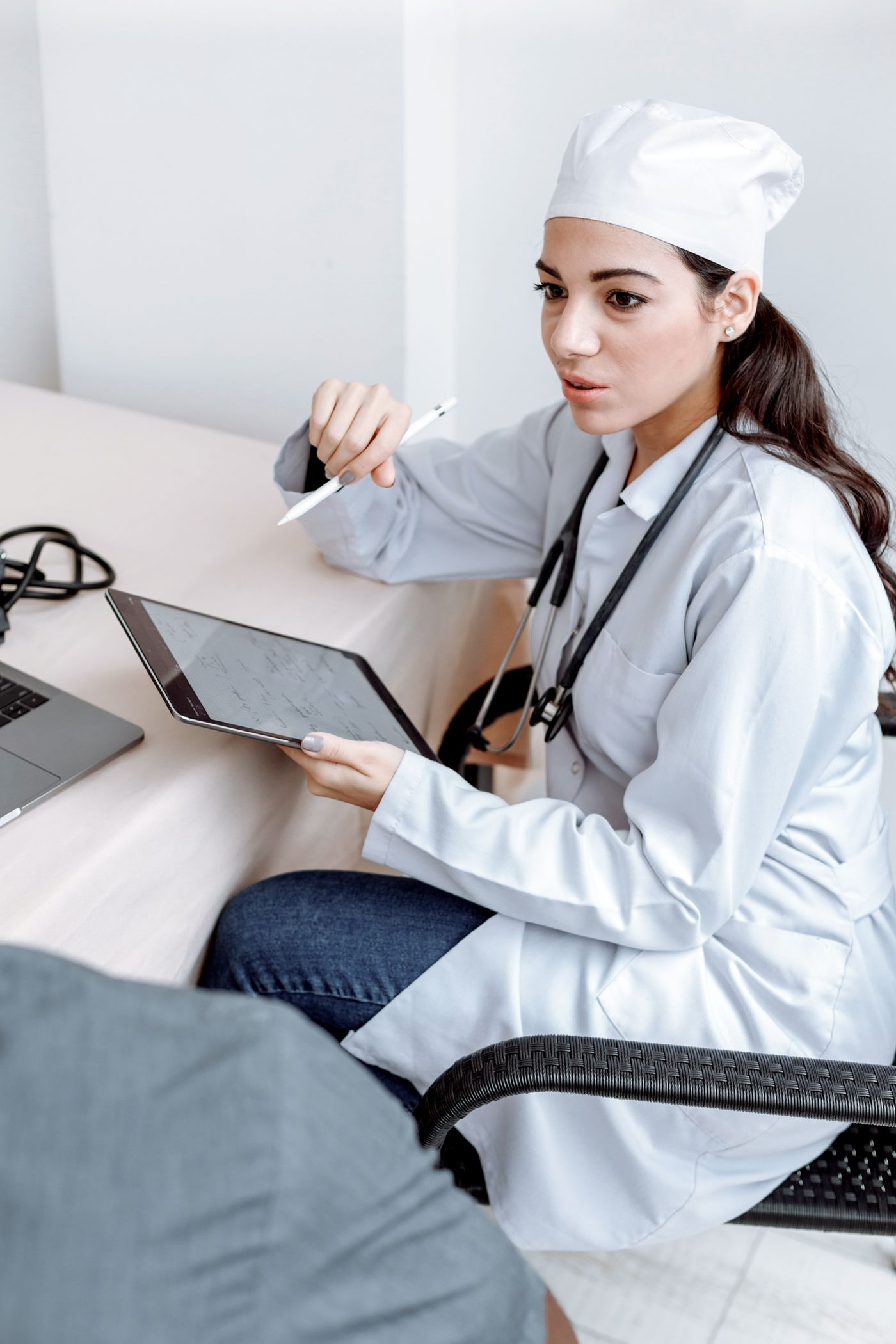 Medical professional discussing an individual assessment with a tablet