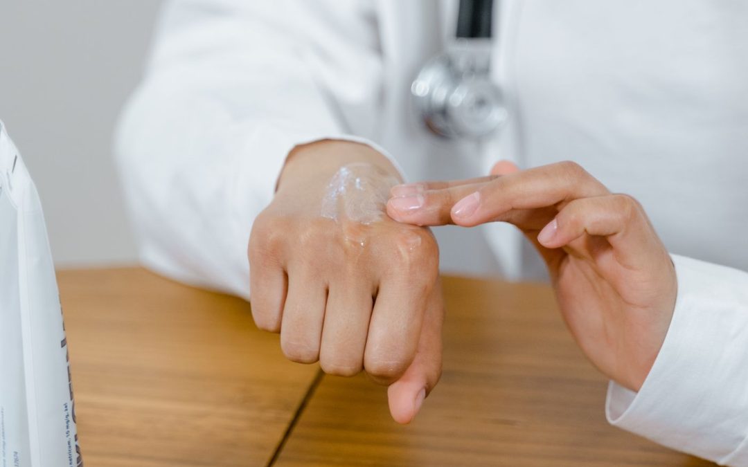 Medical professional demonstrating gentle moisturising care on the hand