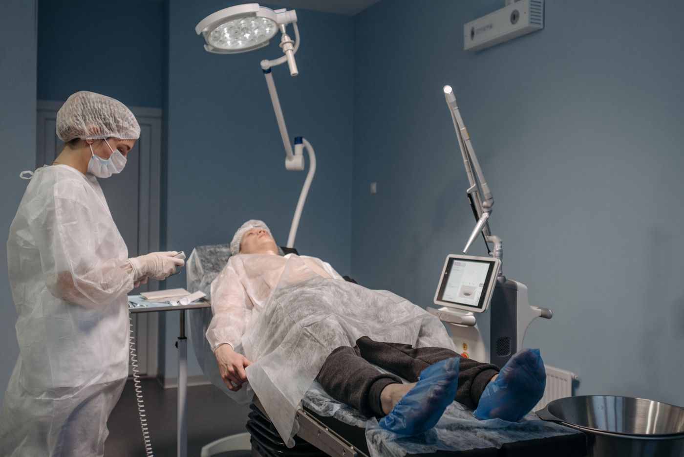 Clinician and patient in a prepared room for a professional skin treatment